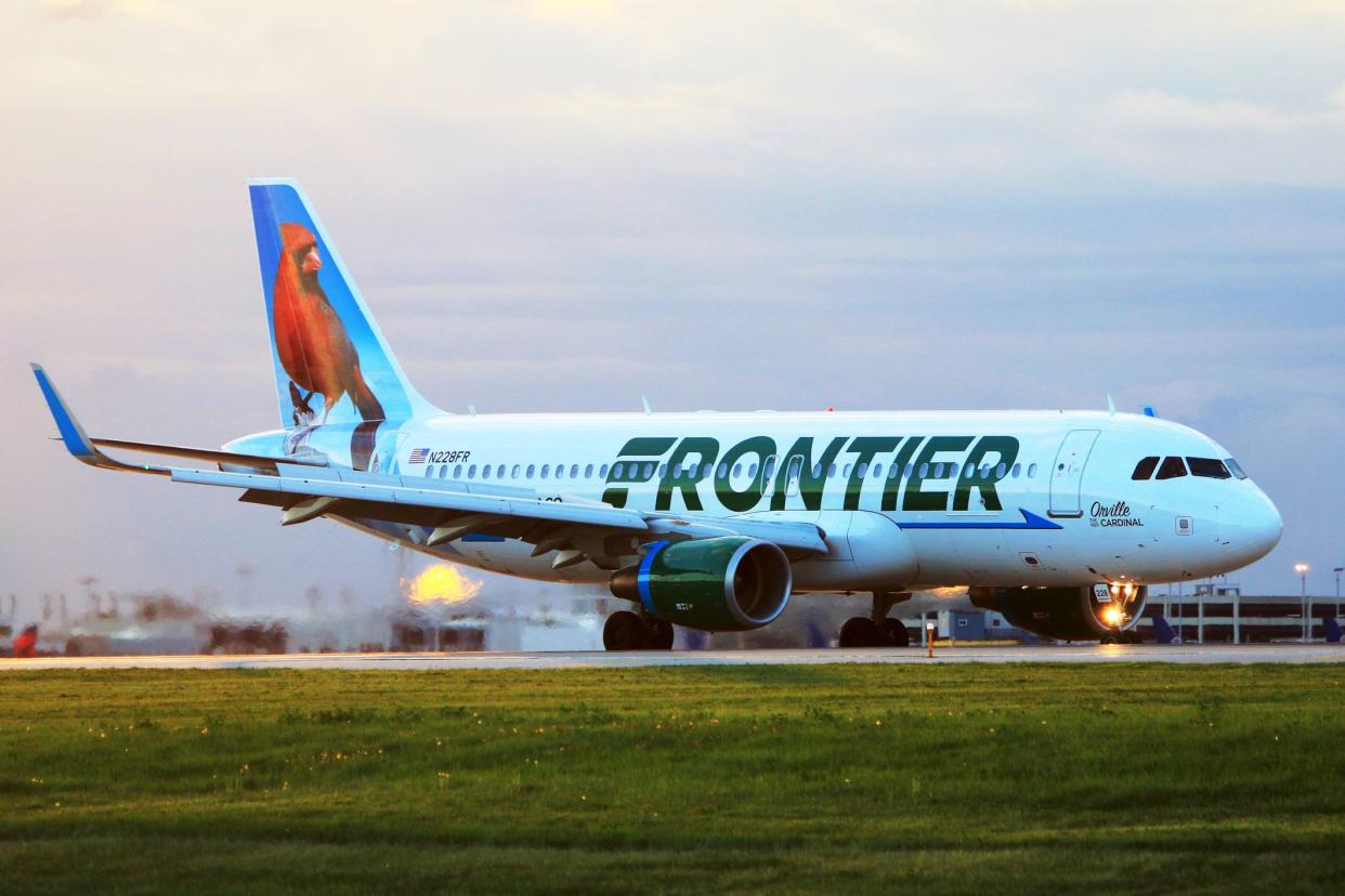 Cleveland, OH, USA - May 12, 2015: In the morning, Frontier Airlines A320 (Orville, the red Cardinal) just landed at Cleveland Hopkins International Airport.