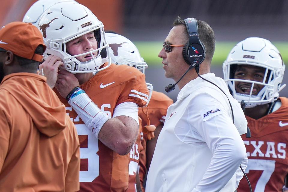 Texas coach Steve Sarkisian talks with quarterback Quinn Ewers during a timeout in the season opener. Ewers could miss multiple games as he deals with a shoulder injury. "Football, you get banged up, and a lot of guys play through a lot of things, and I think that's one of the beauties of our sport is that you find out about yourself," Sarkisian said.