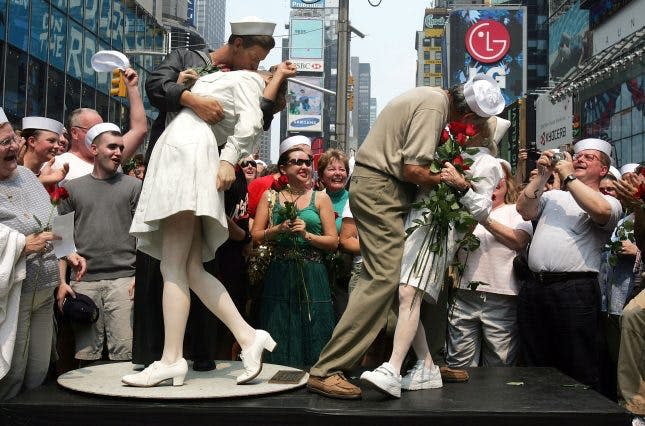 NEW YORK - AUGUST 14: Carl Muscarello and Edith Shain, who claim to be the nurse and sailor in the famous photograph taken on V-J Day, kiss next to a sculpture based on the photograph in Times Square to commemorate the 60th anniversary of the end of World War II August 14, 2005 in New York City. Alfred Eisenstaedt took the famous photograph in Times Square but did not note the names of the people in the picture. (Photo by Mario Tama/Getty Images)