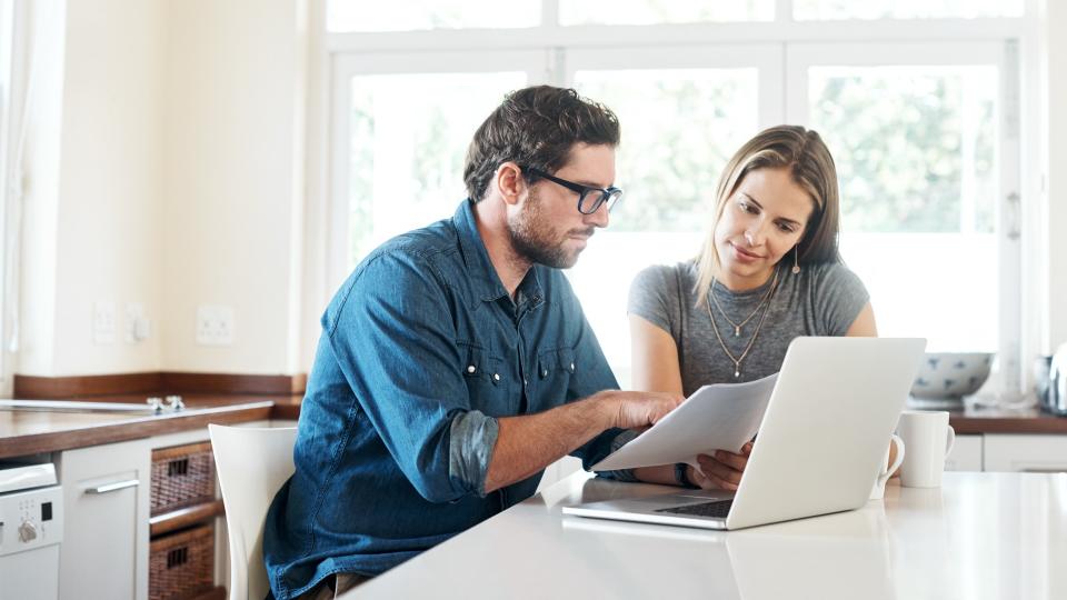 Shot of a young couple working on their finances together at home.