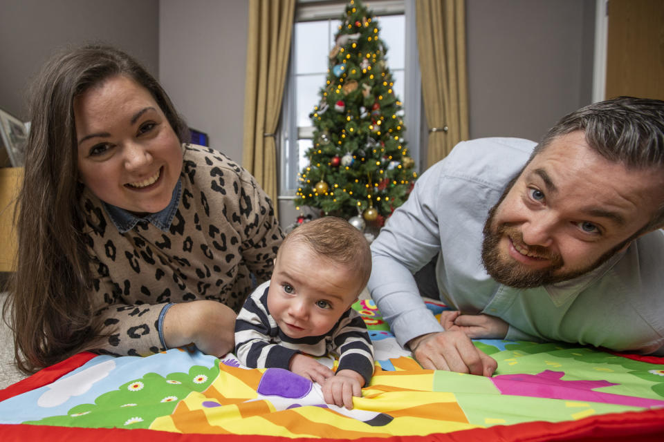 Martin and Gillian Johnston with their son Robbie at their home in Ballyclare (Liam McBurney/PA)