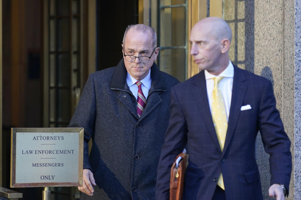 Ed Mullins, left, leaves the courthouse in New York, Wednesday, Feb. 23, 2022. The former New York City police union president who's clashed with city officials over his insulting tweets and combative behavior was ordered released on $250,000 bail after pleading not guilty to a charge that he fraudulently took hundreds of thousands of dollars from the union. (AP Photo/Seth Wenig)