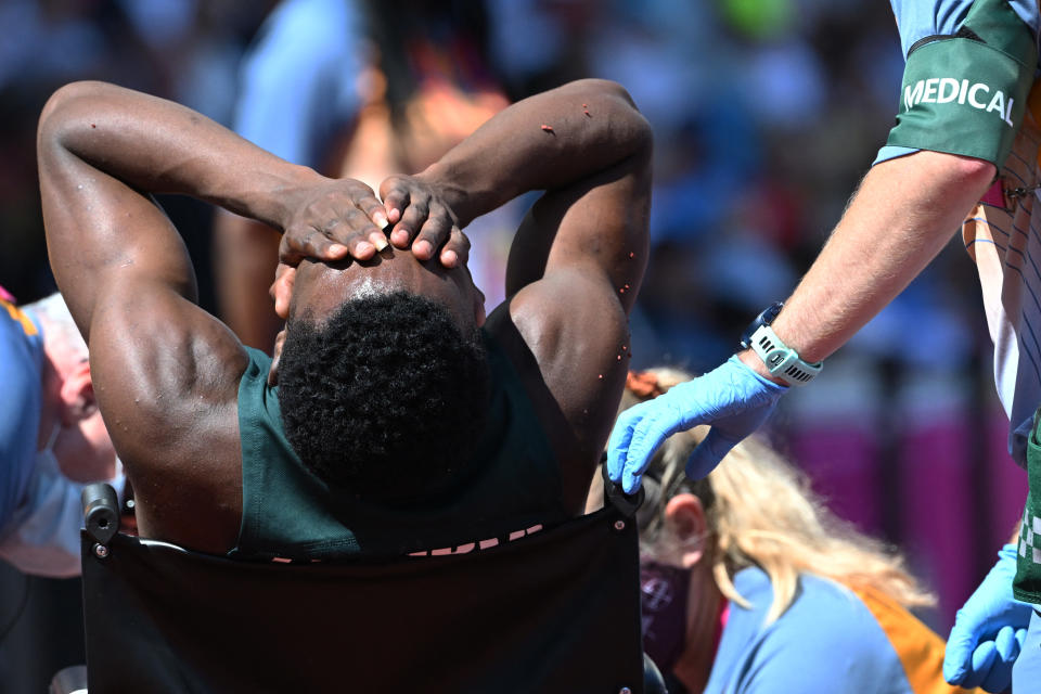 Muzala Samukonga, pictured here being carried on a wheelchair after the 400m heats at the Commonwealth Games.