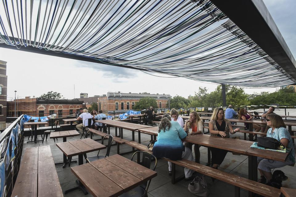 People gather on Illegal Pete's rooftop patio in 2016.