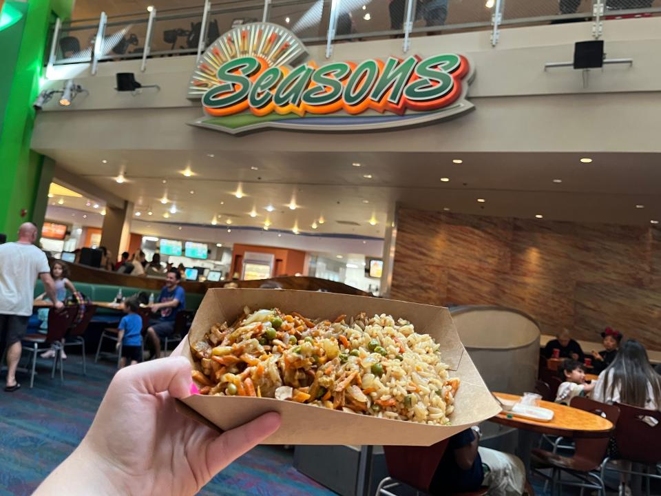 hand holding veggie korma meal from sunshine seasons at epcot