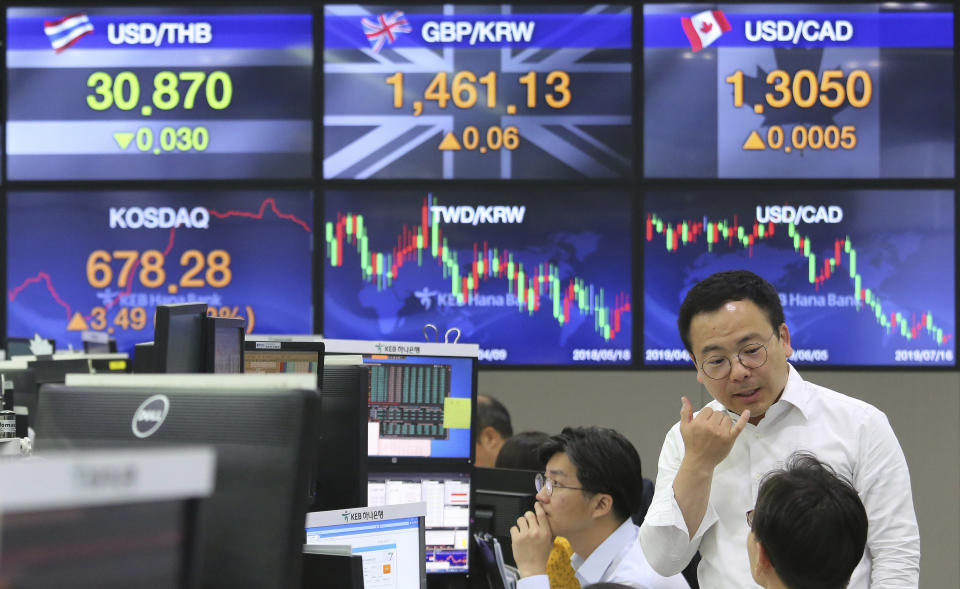 A currency trader gestures at the foreign exchange dealing room of the KEB Hana Bank headquarters in Seoul, South Korea, Tuesday, July 16, 2019. Asian shares were little changed and mixed in quiet trading Tuesday amid a lack of fresh market-moving news as investors looked ahead to earnings season. (AP Photo/Ahn Young-joon)