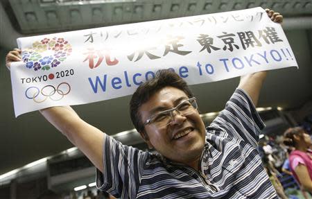 A man celebrates after hearing that Tokyo had been chosen to host the 2020 Olympic Games during a public viewing event in Tokyo September 8, 2013. REUTERS/Toru Hanai