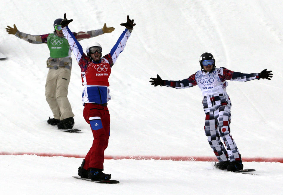 France's Pierre Vaultier, second left, celebrates taking the gold medal ahead of silver medalist Nikolai Olyunin of Russia, right, and bronze medalist Alex Deibold of the United States in the men's snowboard cross final at the Rosa Khutor Extreme Park, at the 2014 Winter Olympics, Tuesday, Feb. 18, 2014, in Krasnaya Polyana, Russia. (AP Photo/Andy Wong)