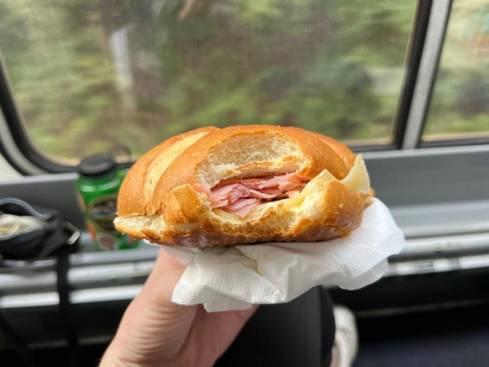 Ham and swiss sandwich on amtrak in front of window