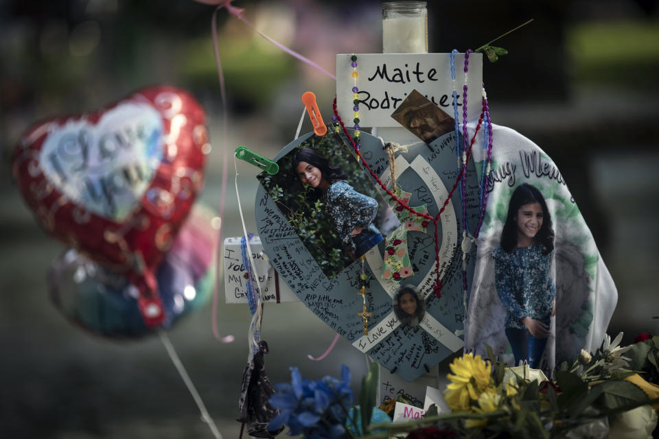 Balloons and Catholic rosaries hang on a cross to honor Maite Yuleana Rodriguez at a memorial site on Saturday, May 28, 2022, in Uvalde, Texas. In a town as small as Uvalde, Texas, even those who didn't lose their own child lost someone in the recent school shooting. Some say now that closeness is both their blessing and their curse: they can lean on each other to grieve. But every single one of them is grieving. (AP Photo/Wong Maye-E)