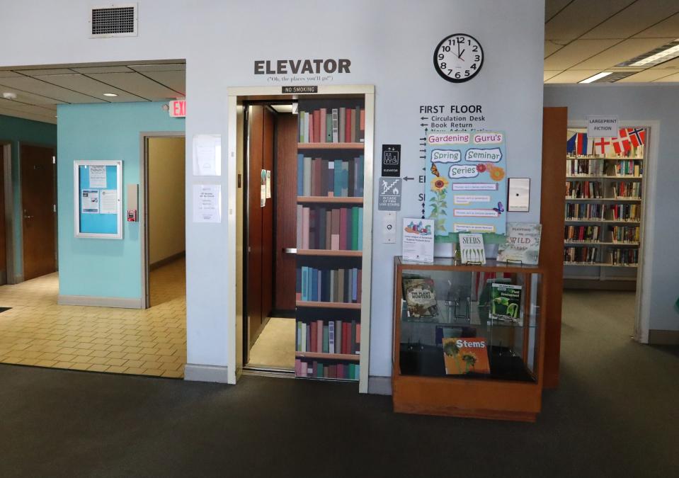 The elevator door at the Live Oak Public Libraries Oglethorpe Mall location is covered to look like shelves of books.