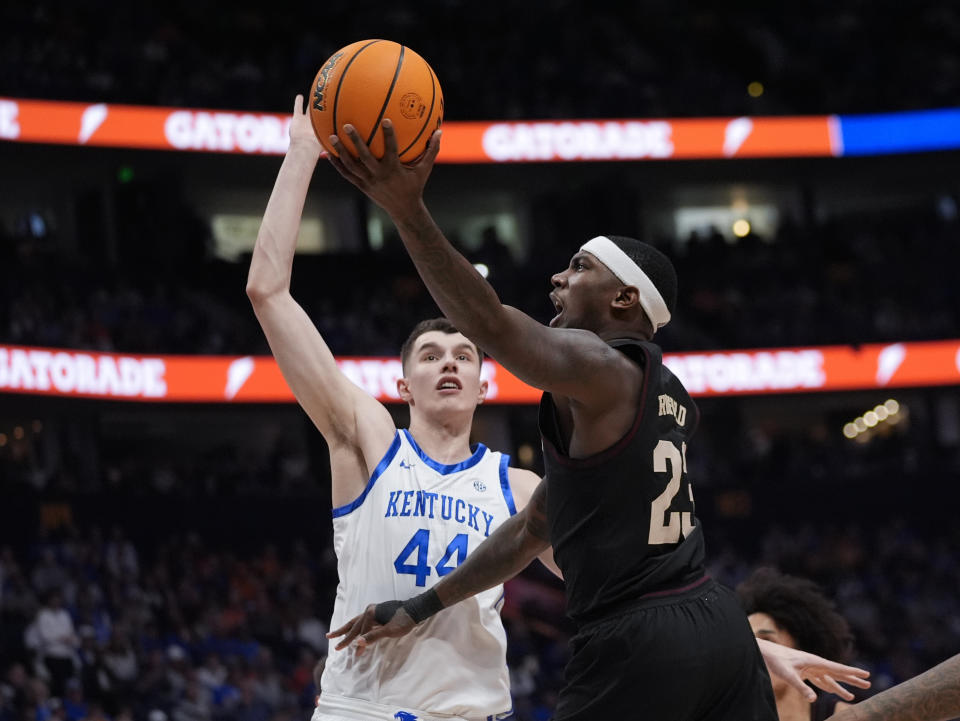 Texas A&M guard Tyrece Radford (23) goes up for a shot as Kentucky forward Zvonimir Ivisic (44) defends during the first half of an NCAA college basketball game at the Southeastern Conference tournament Friday, March 15, 2024, in Nashville, Tenn. (AP Photo/John Bazemore)