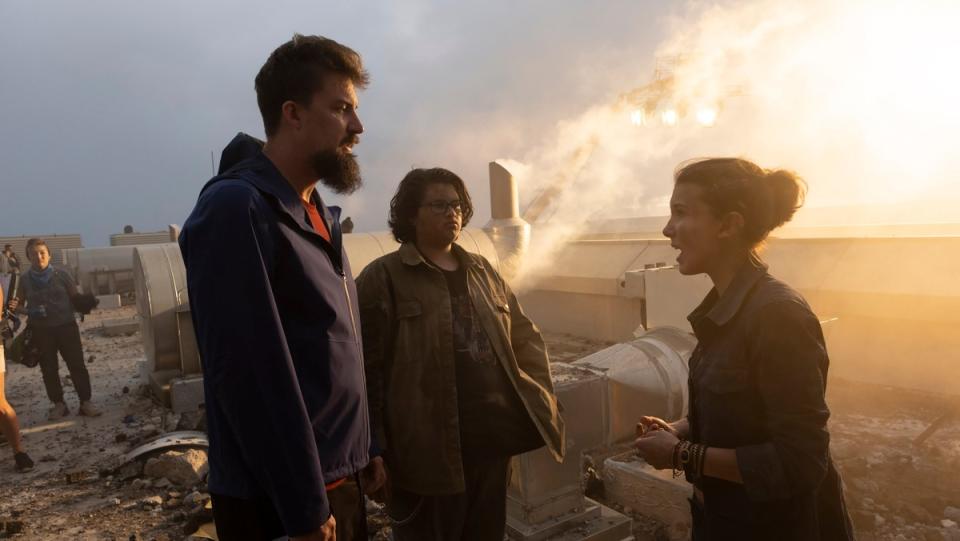 Director Adam Wingard talks to actors Julian Dennison and Millie Bobby Brown on the set of Godzilla vs. Kong.