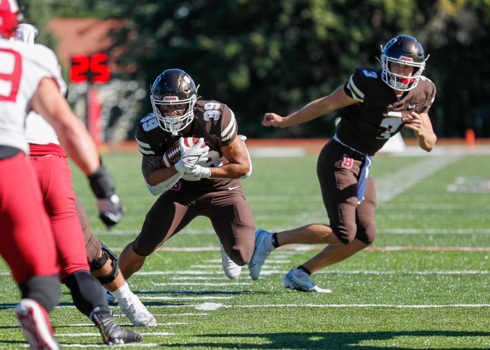 The Bears' Allen Smith takes a handoff from quarterback Jake Willcox during Saturday's game against Harvard.