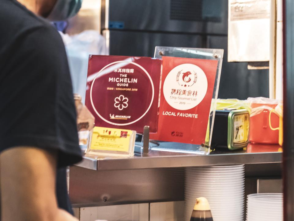 The stall proudly displays its Michelin star plaque.