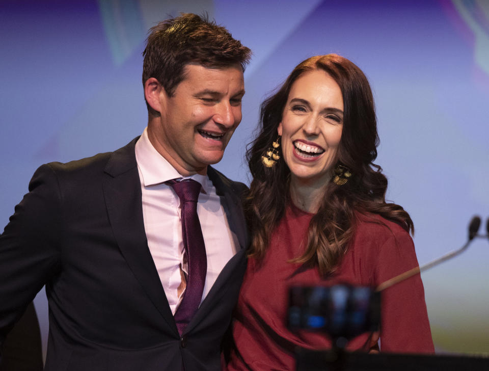 New Zealand Prime Minister Jacinda Ardern, right, is congratulated by her partner Clarke Gayford following her victory speech to Labour Party members at an event in Auckland, New Zealand, Saturday, Oct. 17, 2020. (AP Photo/Mark Baker)