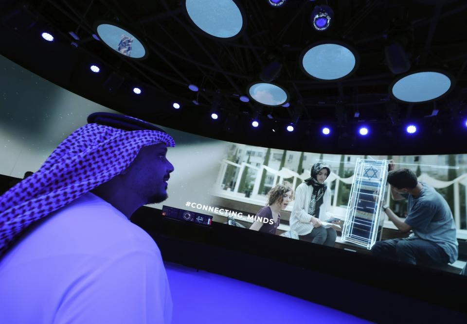 A Journalist watches a show of the Israeli pavilion during a media tour at the Dubai Expo in Dubai, United Arab Emirates, Monday, Sept. 27, 2021. Delayed a year over the coronavirus pandemic, Dubai's Expo 2020 opens this Friday. It will put this city-state all-in on its bet of billions of dollars that the world's fair will boost its economy. (AP Photo/Kamran Jebreili)