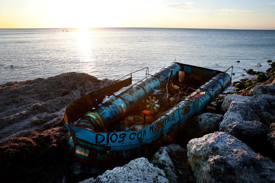 This photo from January shows a boat that was left along the shoreline after it was used recently to transport Cuban migrants from the island nation to America in Key West, Florida. An increasing number of migrants from Cuba and Haiti have been taking to the seas to reach the United States.