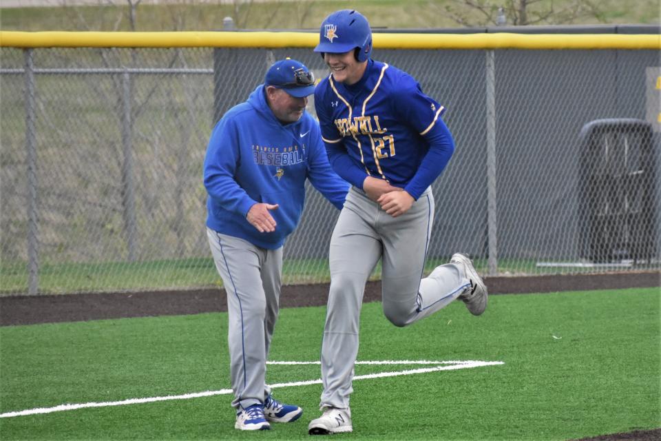 Francis Howell's Brett Norfleet celebrates with Vikings' head coach Tony Perkins after he hit a two-run home run during Francis Howell's 11-0 win over Battle on April 15, 2022, at Battle High School.
