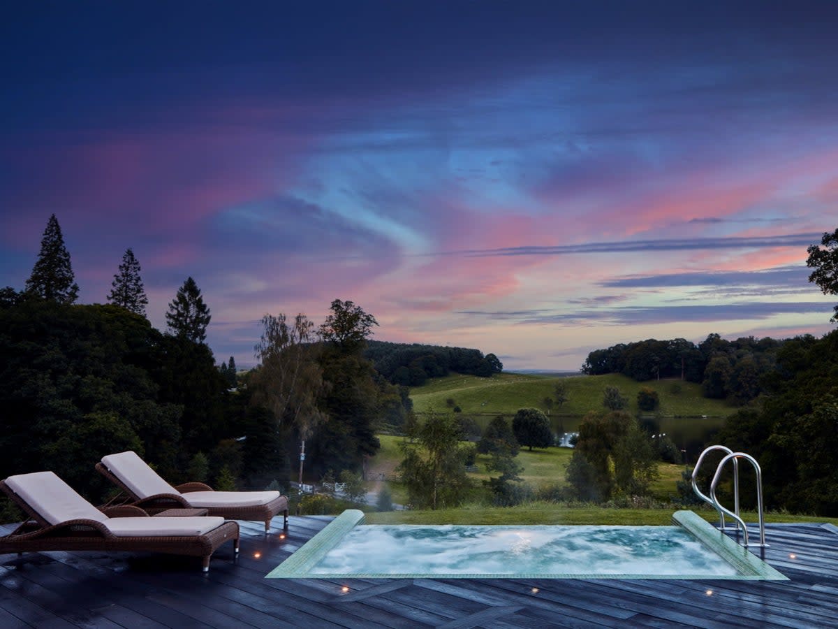 The outdoor infinity pool at Coniston Hotel overlooks rolling hills and a tranquil lake  (Coniston Hotel)