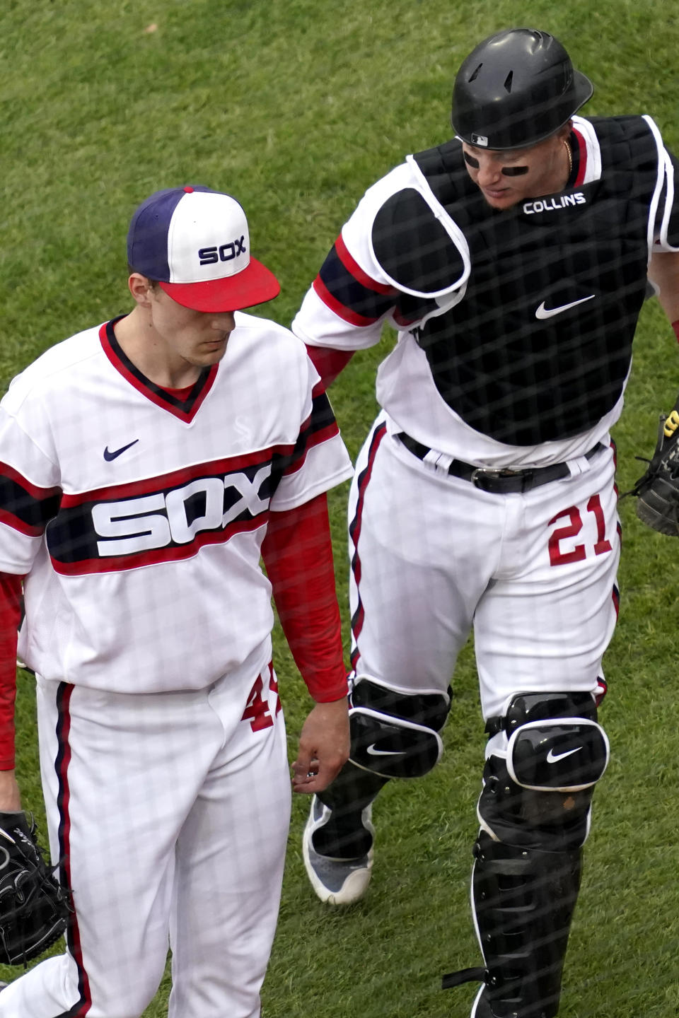Chicago White Sox catcher Zack Collins, right, talks to relief pitcher Garrett Crochet as they walk to the dugout during the 10th inning of a baseball game against the Kansas City Royals in Chicago, Sunday, April 11, 2021. (AP Photo/Nam Y. Huh)
