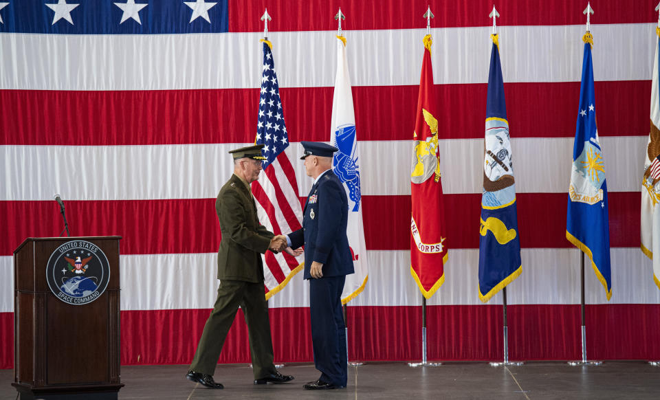 Joint Chiefs of Staff Gen. Joseph F. Dunford, Jr., left, shakes hands with Gen. John W. Raymond, the commander of the U.S. Space Command, Sept. 9, 2019, during a ceremony to recognize the establishment of the United States Space Command at Peterson Air Force Base in Colorado Springs, Colo. (Christian Murdock/The Gazette via AP)
