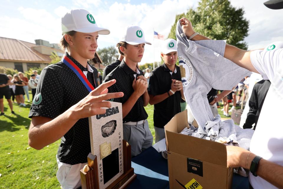 Olympus High School’s Will Pedersen gets a shirt after Olympus won the 5A boys state golf championship at Fox Hollow Golf Club in American Fork on Tuesday, Oct. 10, 2023. Pedersen placed second as an individual. | Kristin Murphy, Deseret News