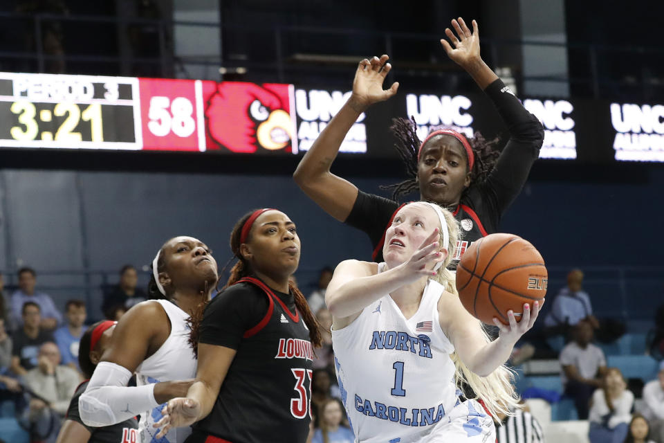 North Carolina guard Taylor Koenen (1) drives to the basket against Louisville forward Bionca Dunham (33) and guard Jazmine Jones, rear, while North Carolina center Janelle Bailey (30) assists during the second half of an NCAA college basketball game in Chapel Hill, N.C., Sunday, Jan. 19, 2020. (AP Photo/Gerry Broome)
