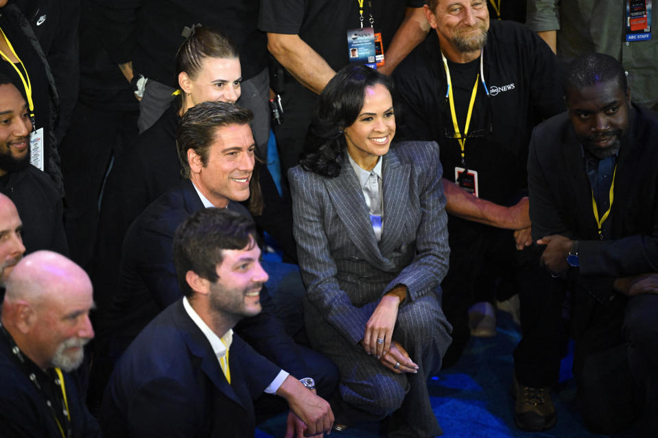 US broadcaster David Muir and US broadcaster Linsey Davis pose for pictures with ABC News crew members at the end of a presidential debate with US Vice President and Democratic presidential candidate Kamala Harris and former US President and Republican presidential candidate Donald Trump at the National Constitution Center i. Philadelphia, Pennsylvania, on September 10, 2024.