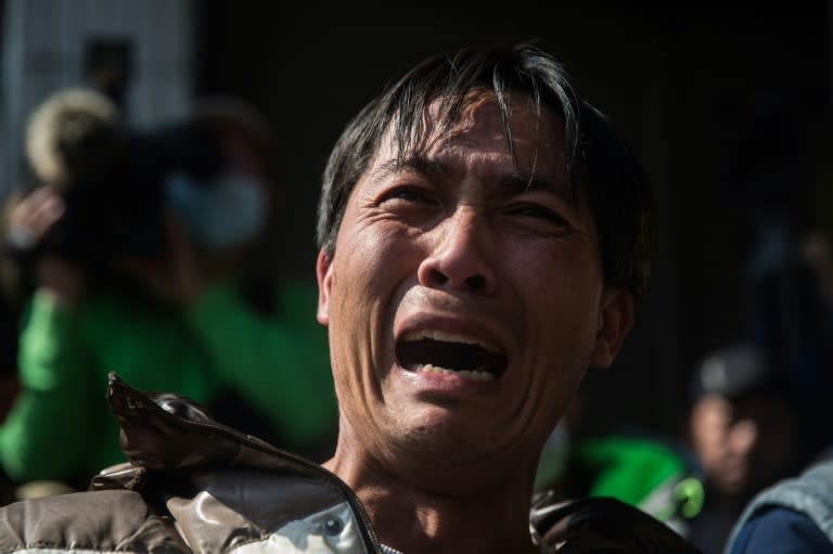 A distraught relative cries as he is briefed on the rescue effort in the southern Taiwanese city of Tainan, on February 9, 2016