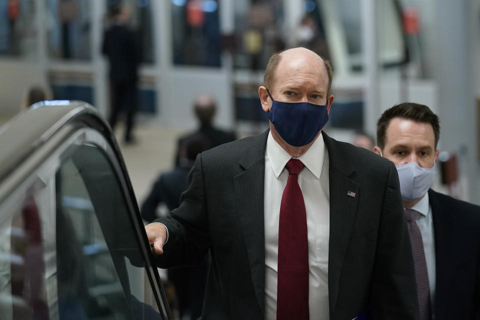 Sen. Chris Coons, D-Del., rides an escalator on Capitol Hill in Washington, Wednesday, Feb. 10, 2021, as he heads to the second day of the second impeachment trial of former President Donald Trump. (AP Photo/Susan Walsh)