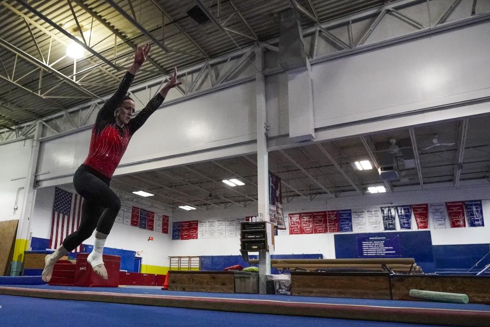 Former gymnastics world champion and Olympic silver medalist Chellsie Memmel works out Thursday, Feb. 18, 2021, in New Berlin, Wisc. The married mother of two is making an unlikely comeback.(AP Photo/Morry Gash)