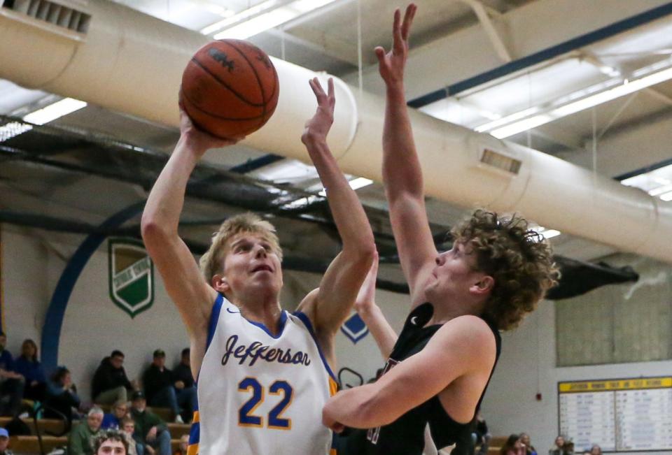 Ben Merkel of Jefferson puts up a shot over New Boston Huron's Nate Morse during a 53-46 Jefferson victory Tuesday night.