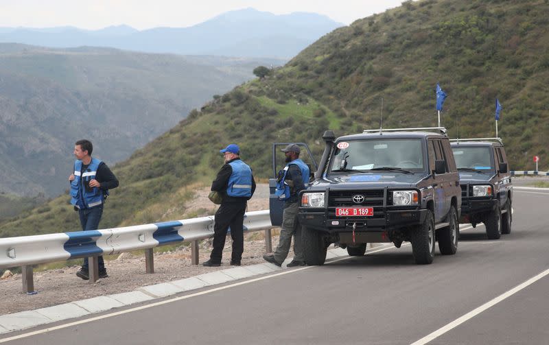 EU observers stand on a road near the Armenia-Azerbaijan border