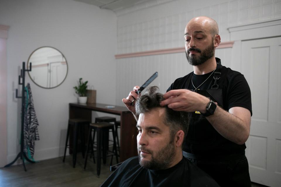 Independent Hair Stylist Gregory Routt styles the hair of Bryan Davis, of Chillicothe, at Salon Niche on April 13, 2023, in Chillicothe, Ohio. Routt is registering his business with an organization called "Strands fo Trans" which allows those who identify as LGBTQIA+, and allies, look online for safe places where they can come feel welcomed within the community. Gregory said he just wants to provide a place where people can feel their most authentic selves.