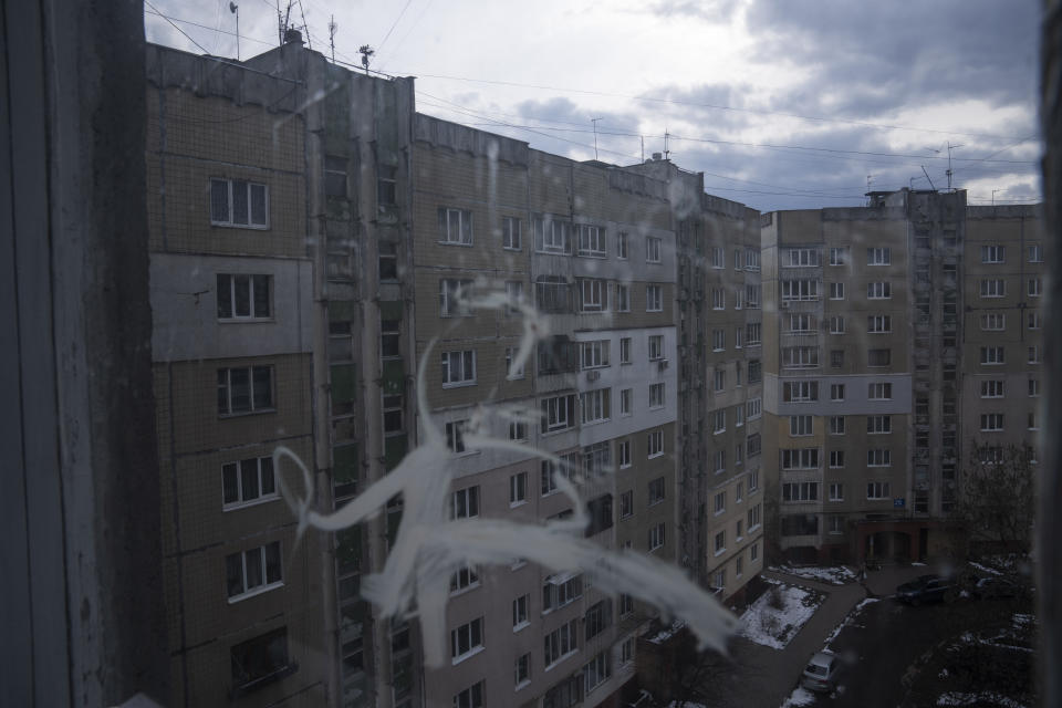 A general view of an apartment block seen from the kitchen window, where the Shlapak family, who are internally displaced from Kharkiv, took refuge, in Lviv, western Ukraine, Sunday, April 3, 2022. On the first day of Russia's invasion, the family left to seek safety in a subway, leaving them homeless for seven days, along with hundreds of other residents. (AP Photo/Nariman El-Mofty)