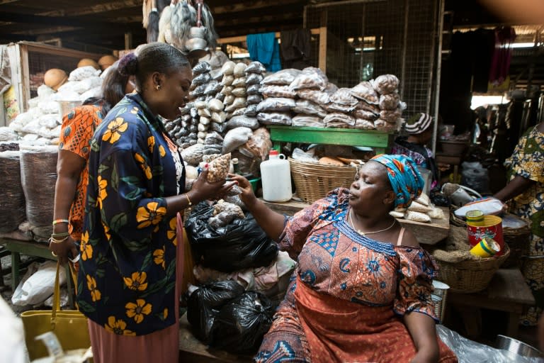 Food entrepreneur Essie Bartels buys spices from trader Aisha Ibrahim at Makola market in Accra