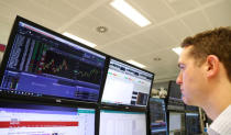 A trader works at his desk whilst screens show market data at CMC Markets in London, Britain, January 16, 2019. REUTERS/John Sibley