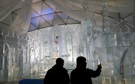 Visitors look at a gothic-style ice dome, made from 90 tonnes of ice, at the mountain resort of Hrebienok near the town of Stary Smokovec, Slovakia November 28, 2016. Picture taken November 28, 2016. REUTERS/David W Cerny