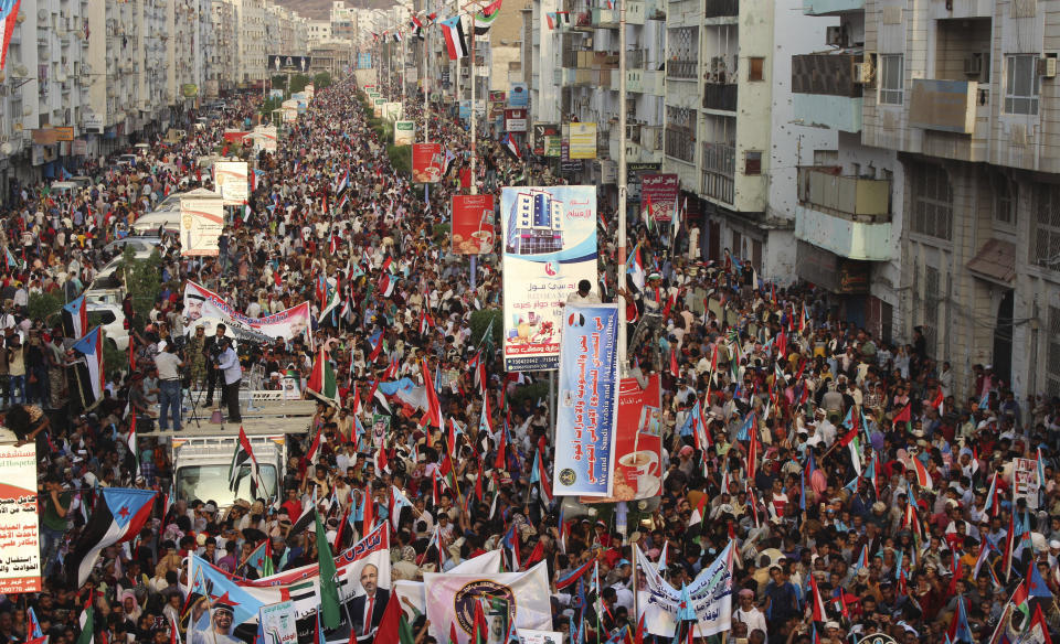 Supporters of southern separatists gather with the flags of south Yemen and the United Arab Emirates during a rally to show support for the UAE amid a standoff with the internationally recognized government, in Aden, Yemen, Thursday, Sept. 05, 2019. Yemeni officials say Saudi Arabia is pushing for a settlement between the internationally recognized government and southern separatists backed by the UAE. They said Thursday that Saudi and UAE officials have met separately to agree on a draft agreement before presenting it to President Abed Rabbo Mansour Hadi and the Southern Transitional Council, which took control of Hadi's interim capital of Aden. (AP Photo/Wail al-Qubaty)