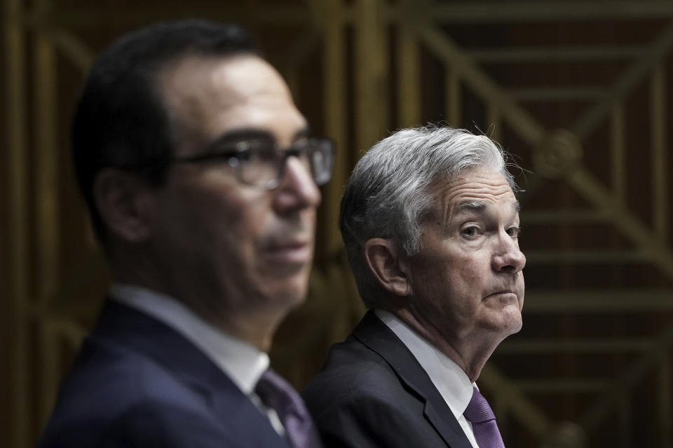 Treasury Secretary Steven Mnuchin, left, and Federal Reserve Board Chairman Jerome Powell testifies during a Senate Banking Committee hearing, Thursday Sept. 24, 2020 on Capitol Hill in Washington about the CARES Act and the economic effects of the coronavirus pandemic. (Drew Angerer/Pool via AP)
