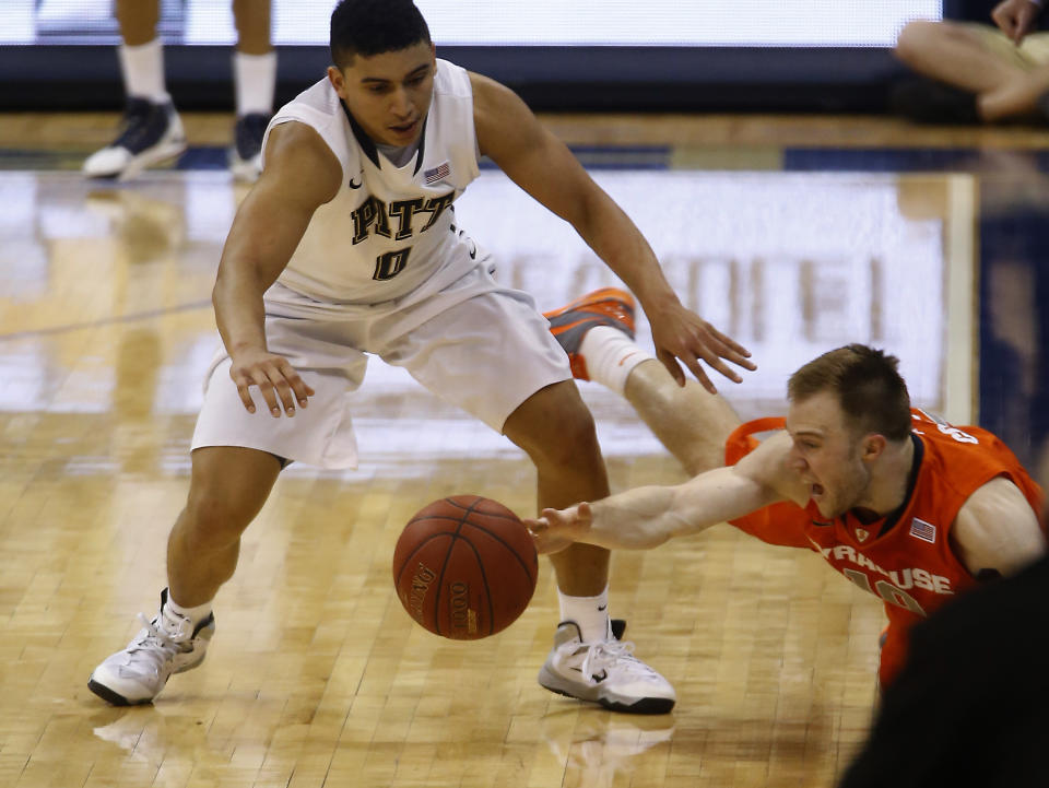 Pittsburgh's James Robinson, left, and Syracuse's Trevor Cooney go for a loose ball during the second half of an NCAA college basketball game Wednesday, Feb. 12, 2014, in Pittsburgh. (AP Photo/Keith Srakocic)