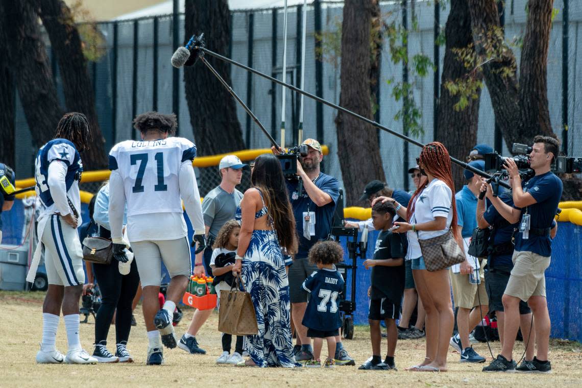 Dallas Cowboys defensive end Randy Gregory, left, and tackle La’el Collins (71) with their families after practice at the NFL football team’s training camp in Oxnard, Calif., in July 2021.