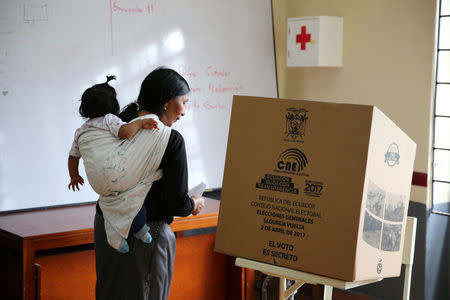 A woman casts her vote in a school used as a polling station during the presidential election, in Quito, Ecuador April 2, 2017. REUTERS/Mariana Bazo