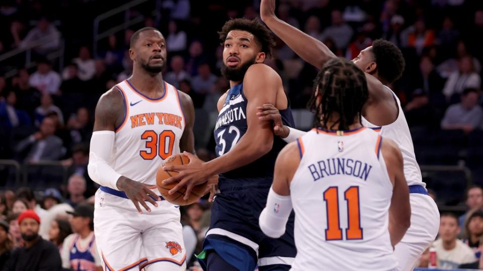 Oct 14, 2023; New York, New York, USA; Minnesota Timberwolves center Karl-Anthony Towns (32) controls the ball against New York Knicks forward Julius Randle (30) and guards RJ Barrett (9) and Jalen Brunson (11) during the first quarter at Madison Square Garden.