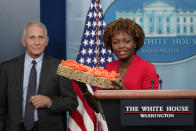 White House press secretary Karine Jean-Pierre delivers cookies to members of the press before speaking at a press briefing alongside Dr. Anthony Fauci, Director of the National Institute of Allergy and Infectious Diseases, at the White House, Tuesday, Nov. 22, 2022, in Washington. (AP Photo/Patrick Semansky)