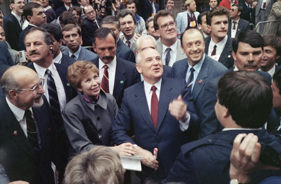 FILE - Soviet President Mikhail Gorbachev, with his wife Raisa at left, talks with spectators during a walk through an outdoor pedestrian mall in Ottawa, Tuesday, May 29, 1990. Gorbachev was in Canada for a two-day visit before heading to Washington for the 1990 superpower summit. When Mikhail Gorbachev is buried Saturday at Moscow's Novodevichy Cemetery, he will once again be next to his wife, Raisa, with whom he shared the world stage in a visibly close and loving marriage that was unprecedented for a Soviet leader. Gorbachev's very public devotion to his family broke the stuffy mold of previous Soviet leaders, just as his openness to political reform did. (AP Photo/Tom Stathis, File)