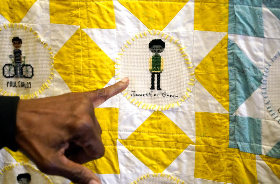 A portrait of the late civil rights activist Medgar Evers is among the 116 cross-stitched images adorning one of two hand crafted quilts honoring African Americans who lost their lives to racial violence, as part of the Stitch Their Name Memorial Project, on display at the Margaret Walker Center at Jackson State, Tuesday, Nov. 30, 2021, in Jackson, Miss. (AP Photo/Rogelio V. Solis)