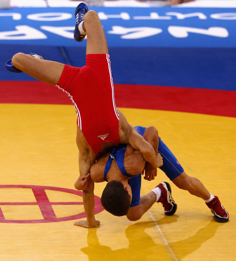 Elman Mukhtarov of Azerbaijan competes against Nurbek Hakkulov of Uzbekistan in the final of the Men's Greco Roman 50kg Wrestling competition on day one of the Youth Olympics at the International Convention Centre on August 15, 2010 in Singapore. (Mark Dadswell/Getty Images)