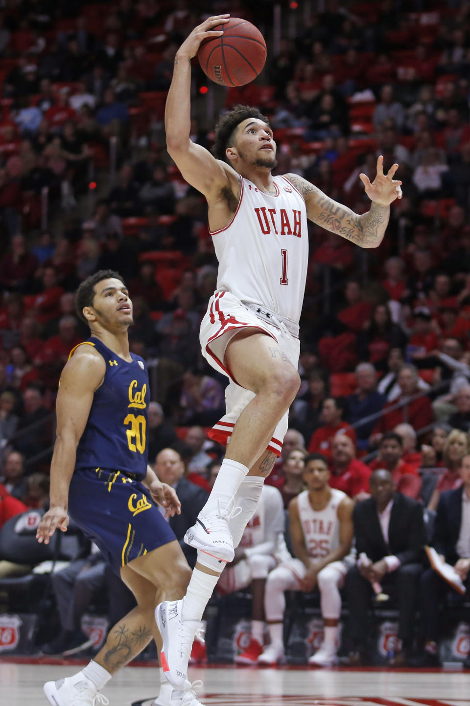 Utah forward Timmy Allen (1) goes to the basket as California guard Matt Bradley (20) watches during the second half of an NCAA college basketball game Saturday, Feb. 8, 2020, in Salt Lake City. (AP Photo/Rick Bowmer)